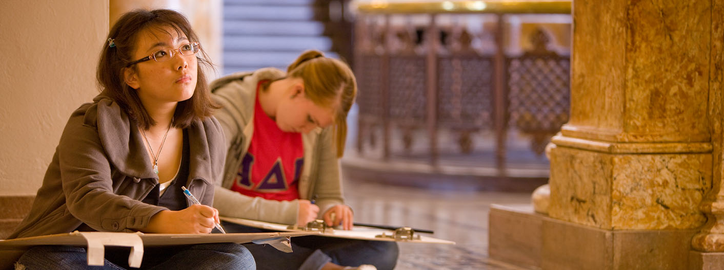 Two students drawing in Beardshear Hall.