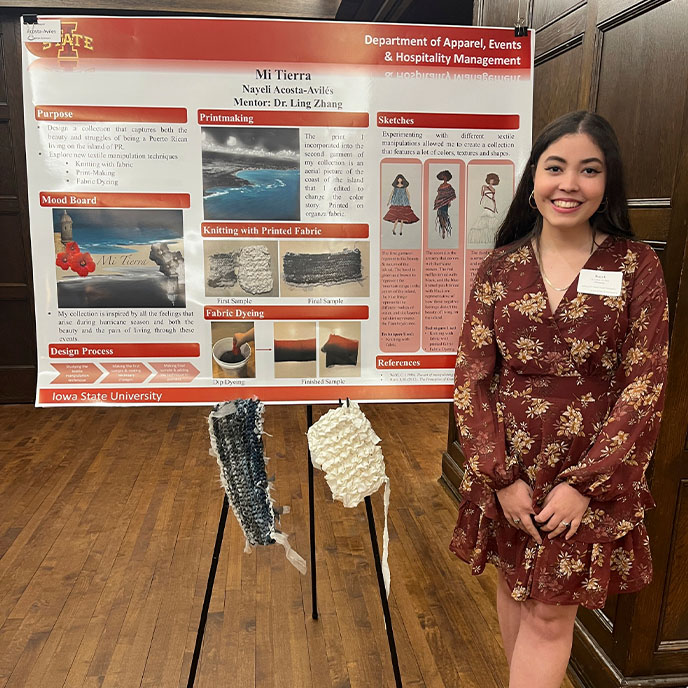 Female honors student presenting her research at the Spring 2023 poster session.