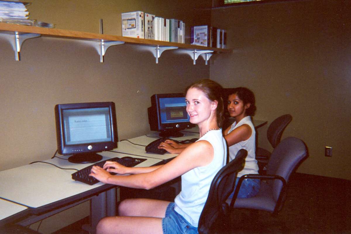 Vintage photo of two female honors students at computers.